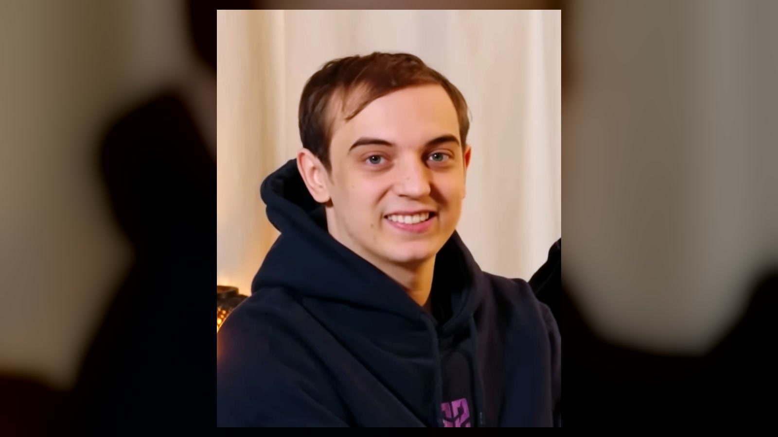 Caps smiling in a G2 Esports hoodie during a 2023 team video.
