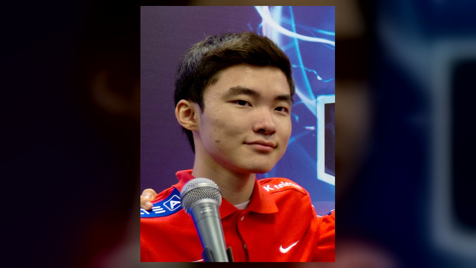 A young Faker holding a microphone after the 2013 League of Legends World Championship final.